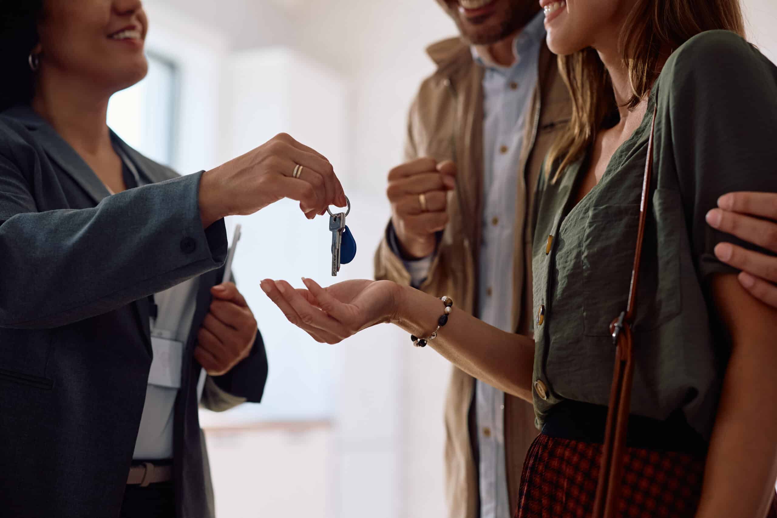 Saving for a down payment, realtor giving keys to homeowner, first-time homebuyer
