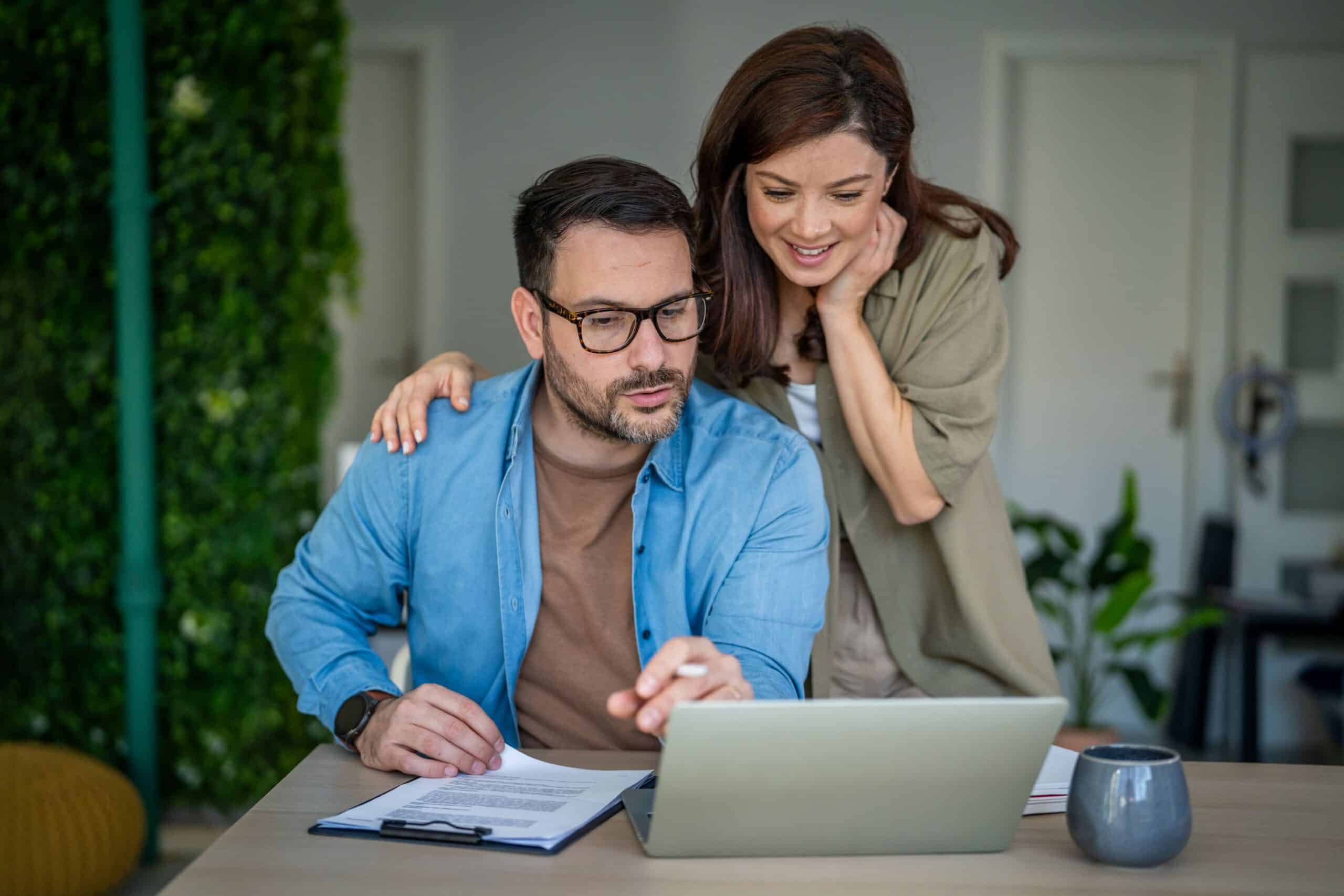 couple reviewing finances, couple reviewing financial documents, common banking mistakes, avoid common banking mistakes, how to avoid costly banking mistakes